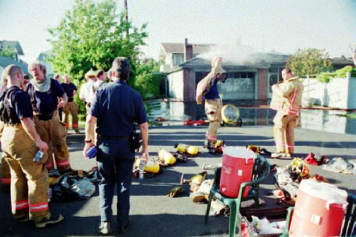 Neil Carlberg, second from left, is shown with other Bellingham firefighters at a fire in an undated file photo. It was estimated Carberg 900 to 1,200 fires in his 33-year career with Bellingham Fire.