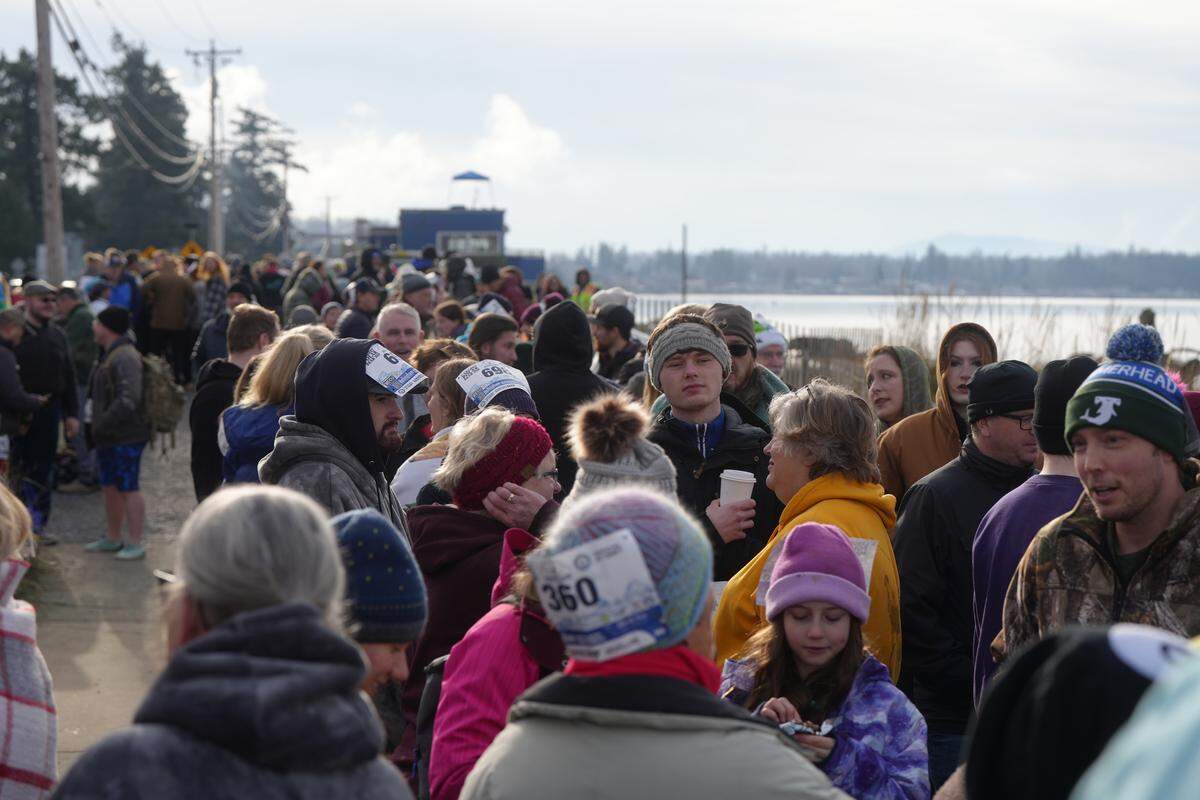Participants tried to stay warm as they waited to attempt to break the world record for the largest polar bear dip Thursday in Birch Bay, Wash.