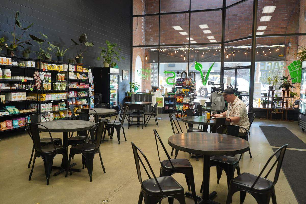A customer eats lunch inside Sage Against the Machine on Wednesday, Oct. 12, in Bellingham.