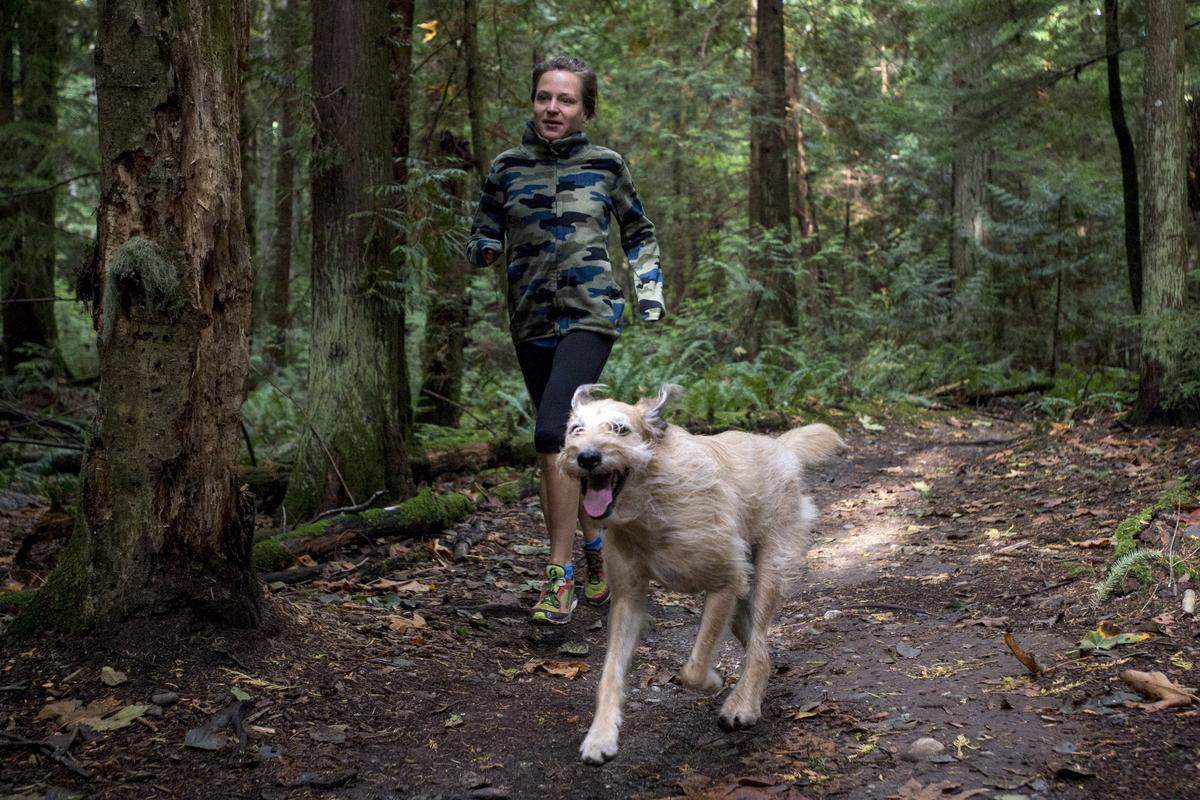 Jodee Adams-Moore runs with her dog Pablo at Lake Padden Park in 2014.