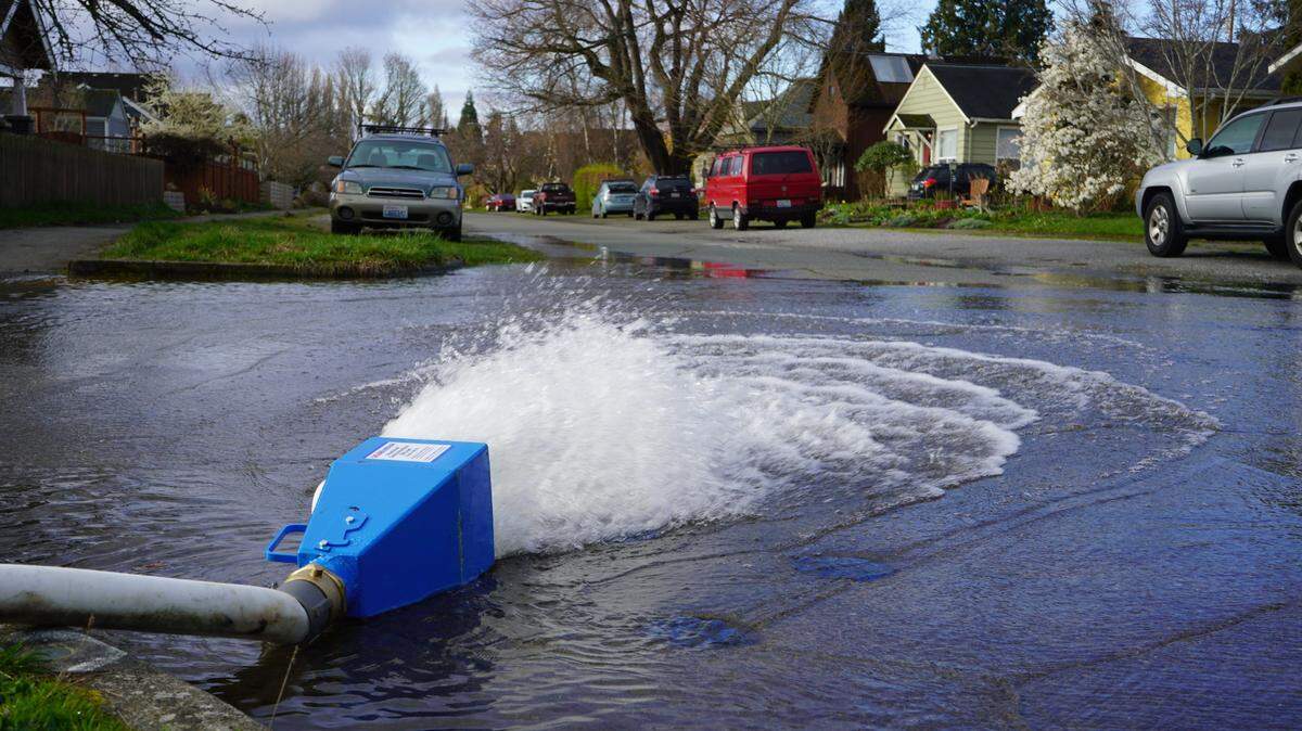 Water is de-chlorinated in the blue box before being discharged into the city’s storm drainage system as the city of Bellingham flushed water mains Tuesday, April 4, in the Columbia neighborhood.