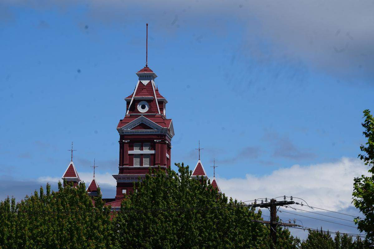 Whatcom Museum’s Old City Hall peaks through the trees on May 29, 2025, in Bellingham, Wash.