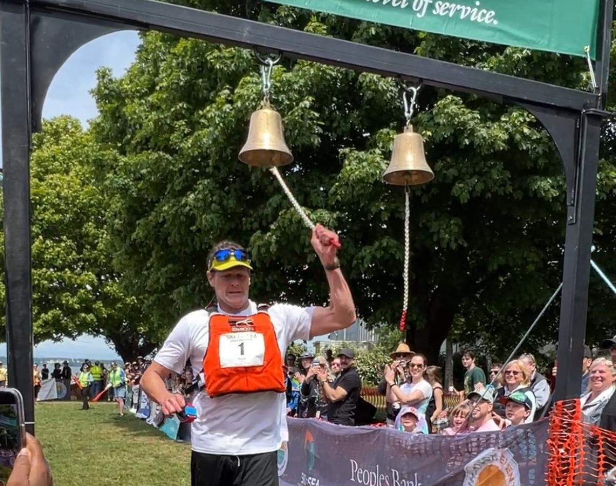 Jeff Hilburn rings the bell at Marine Park in Bellingham to win the 52nd Ski to Sea race for Birch Equipment on May 25, 2025.