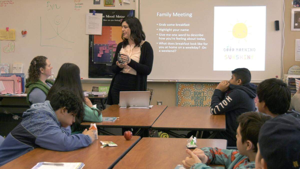 Dara Yost discusses the importance of breakfast with her students in her classroom at Shuksan Middle School.