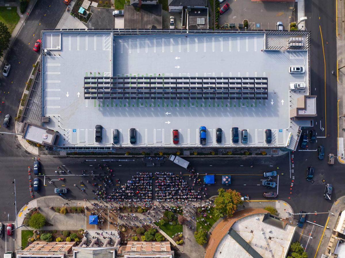 An aerial view shows community members gathering for a ribbon-cutting ceremony of the Mount Vernon Library Commons on Saturday, September 28, 2024, in Mount Vernon, Wash.