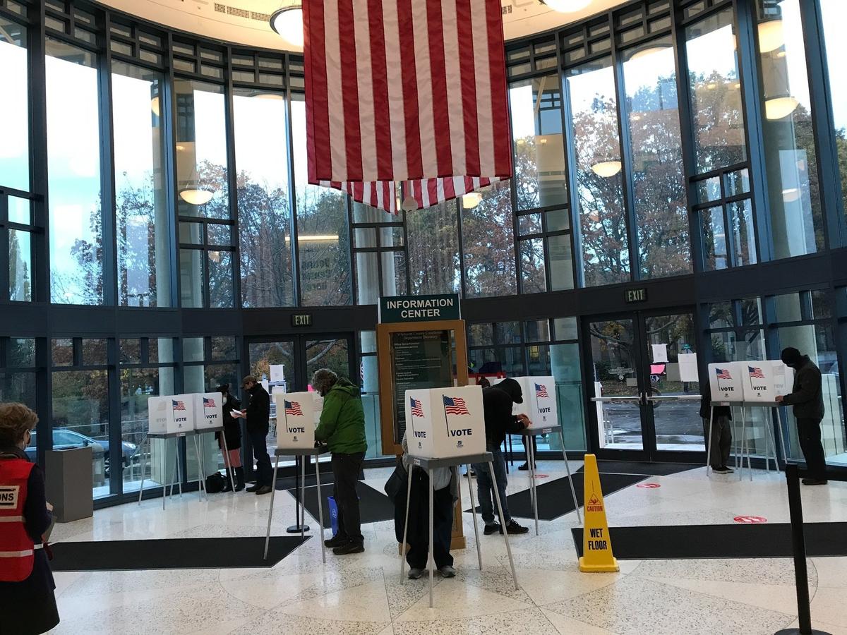 People vote at socially-distanced ballot booths in the rotunda at the Whatcom County Court House and Civic Center on Tuesday, Nov. 3.