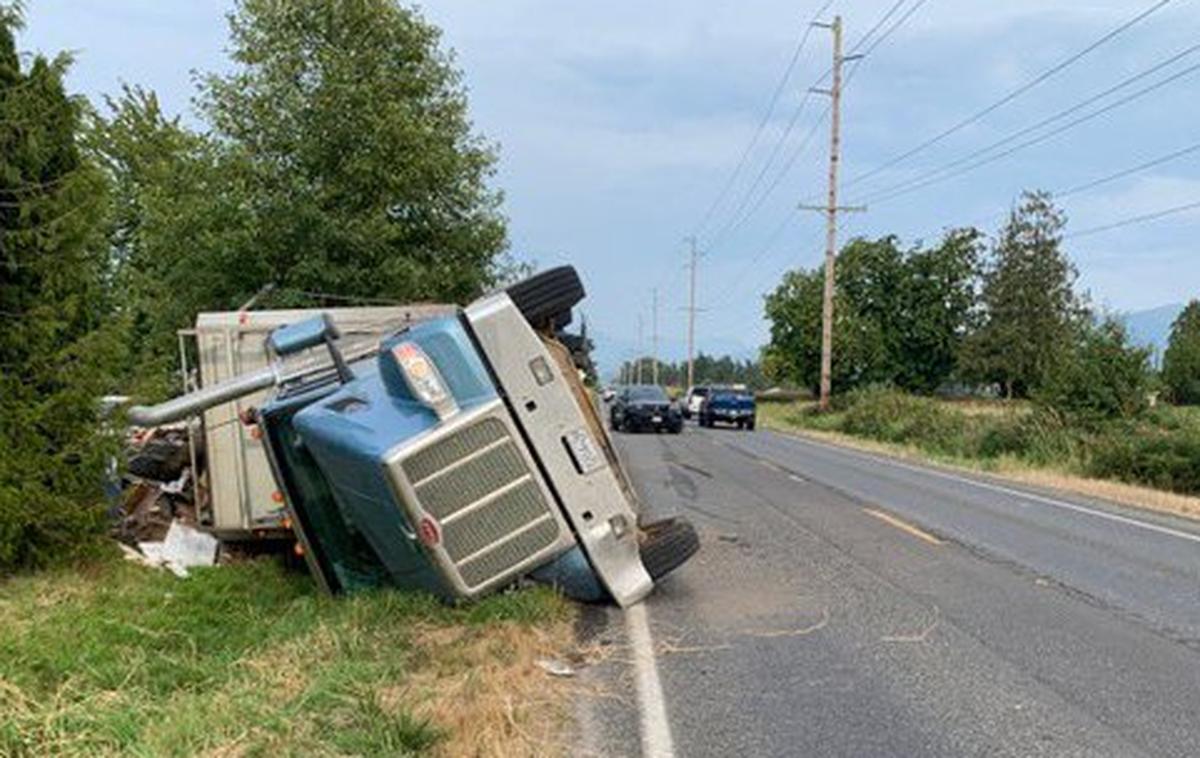 A semi-truck carrying garbage rolled Thursday evening, Aug. 19, along State Route 546 in Whatcom County.