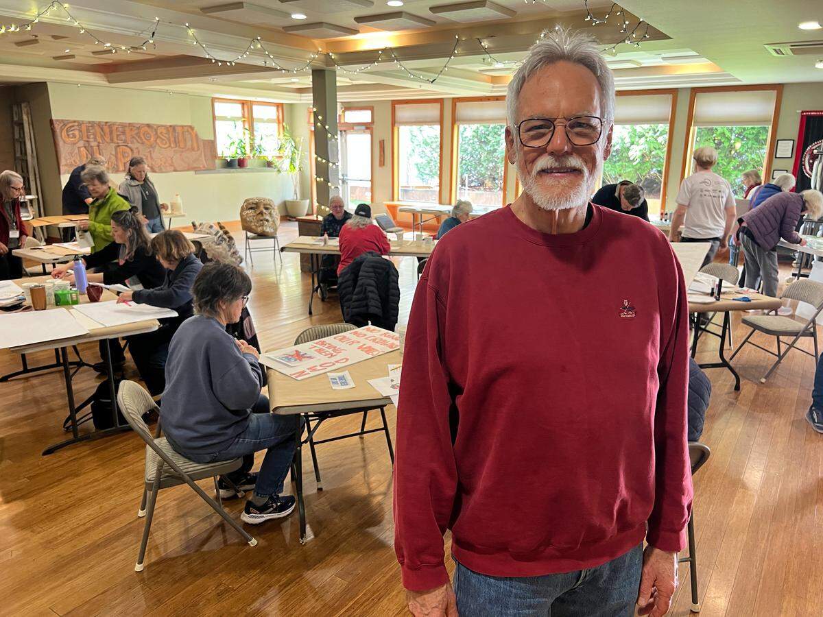 Kevin Leja of Indivisible Bellingham is shown at a sign-making event on March 14, 2026, at the Bellingham Unitarian Fwllowship in Bellingham, Wash.