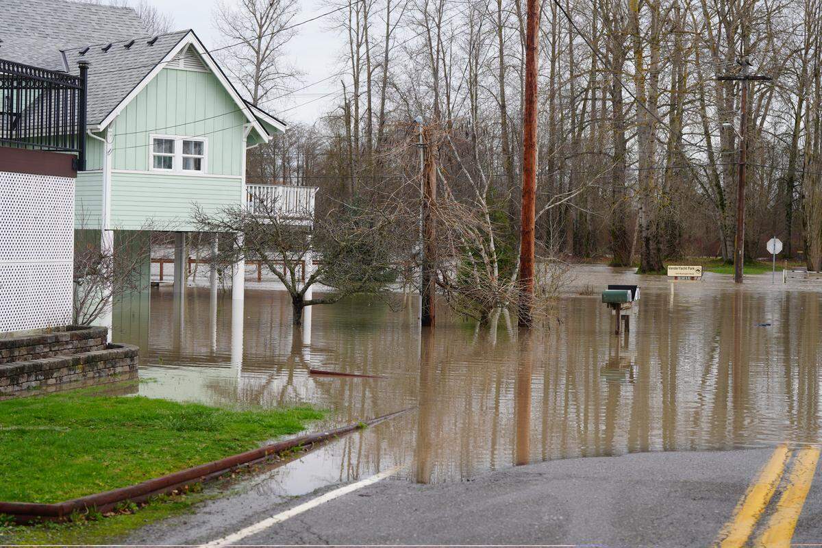 A residence on the corner of Washington Street and Portal Way was surrounded by floodwaters from the Nooksack River on December 10, 2025, in Ferndale, Wash.