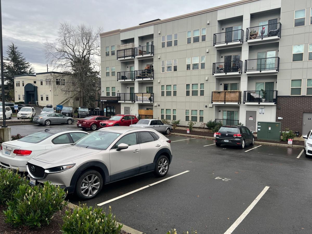 An apartment building has a parking lot for residents in the Lettered Streets neighborhood of Bellingham.