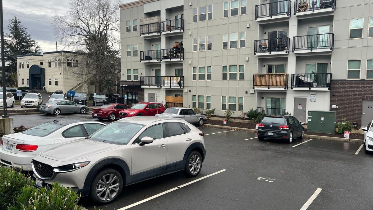 An apartment building has a parking lot for residents in the Lettered Streets neighborhood of Bellingham.