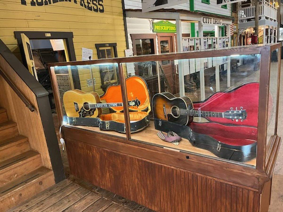 A replica of Loretta Lynn’s guitar (left) is displayed next to Darlene Little’s guitar (right) at the Lynden Heritage Museum.