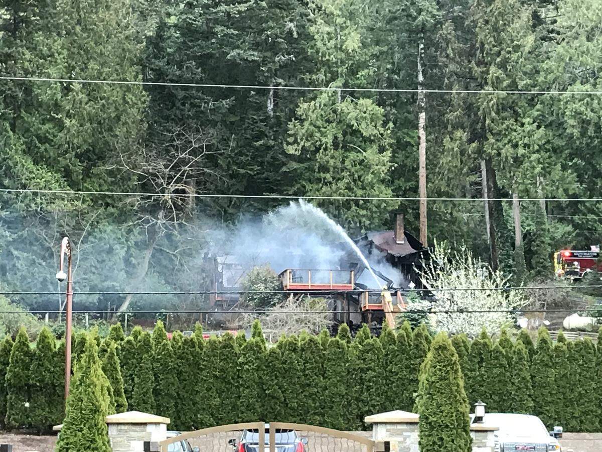 Fire crews continue Wednesday morning to work the scene of a two-alarm structure fire in the 900 block of Chuckanut Drive south of Bellingham.