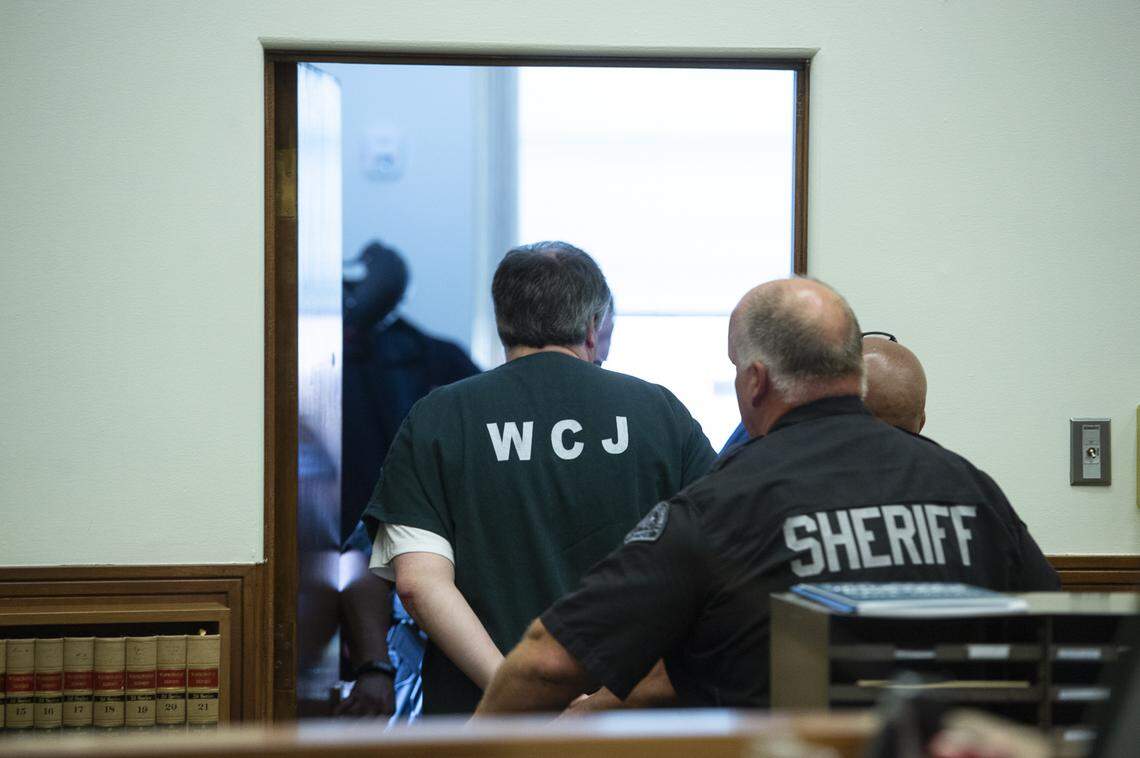 Timothy Forrest Bass, left, is led out of the Whatcom County Superior Court Tuesday after he was sentenced for the 1989 kidnap, rape and murder of 18-year-old Amanda “Mandy” Stavik.