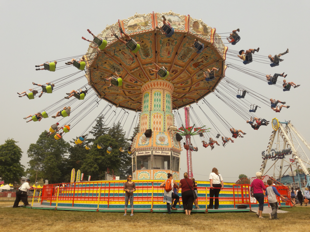 Fairgoers ride the Wave Swinger at the Northwest Washington Fair in Lynden Tuesday afternoon. The weather service is predicting the haze will clear, with sunny skies predicted for Wednesday through Saturday and high temperatures ranging from 81 on Wednesday to 76 the rest of the week.