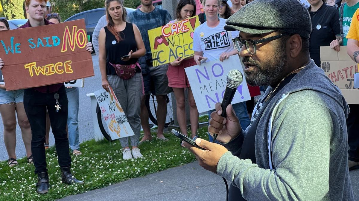 Jason McGill, executive director of Northwest Youth Services, addresses about 100 opponents of the new jail proposal at a rally outside the Whatcom County Courthouse on Tuesday, July 11, 2023, in Bellingham, Wash.