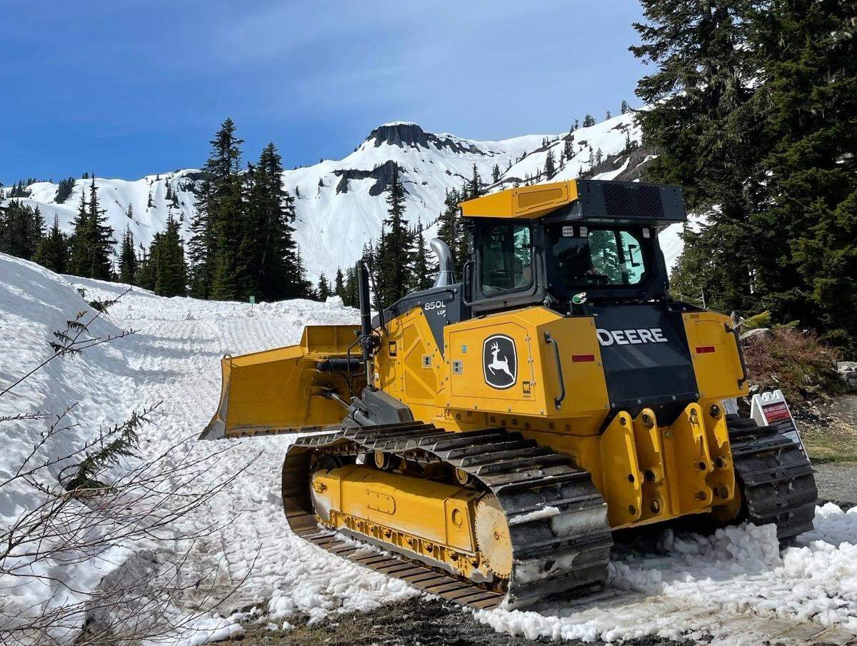 Road-clearing crews with the Washington State Department of Transportation unload bulldozers in the snow near Heather Meadows on Monday, June 2, as clearing efforts started for the road to Artist Point in the Mount Baker-Snoqualmie National Forest east of Bellingham.