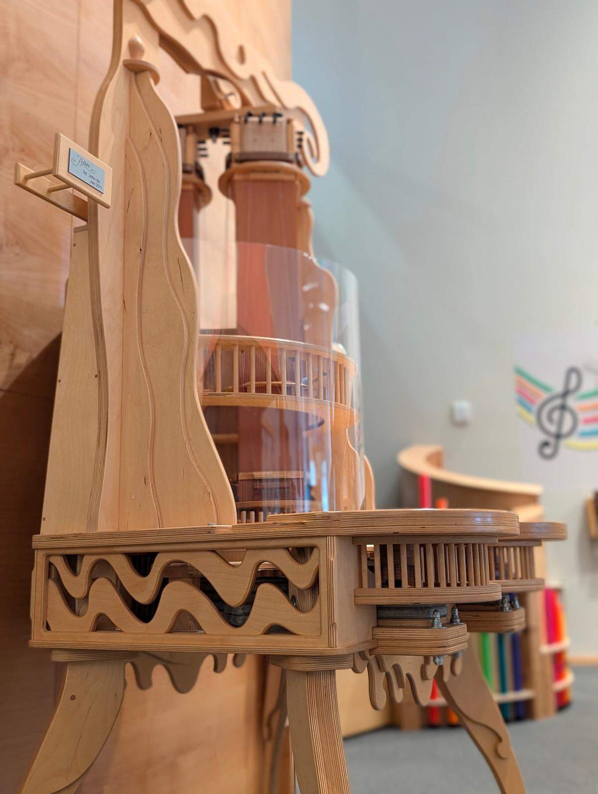 “Alella,” a large musical instrument designed by former Mindport employee John Ito, is described as part guitar and part turntable. Museum visitors can control its tempo with a system of gears that spin guitar strings as they’re plucked by stationary picks. “Allella” has a clear casing, which allows the player to see how the instrument functions.