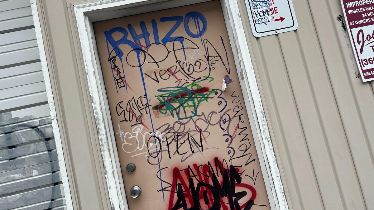 A door that opens to the alley behind Color Pot, 1210 N. State St., shows graffiti from the suspected Rhizo and Home vandals in downtown Bellingham on Monday, May 1.