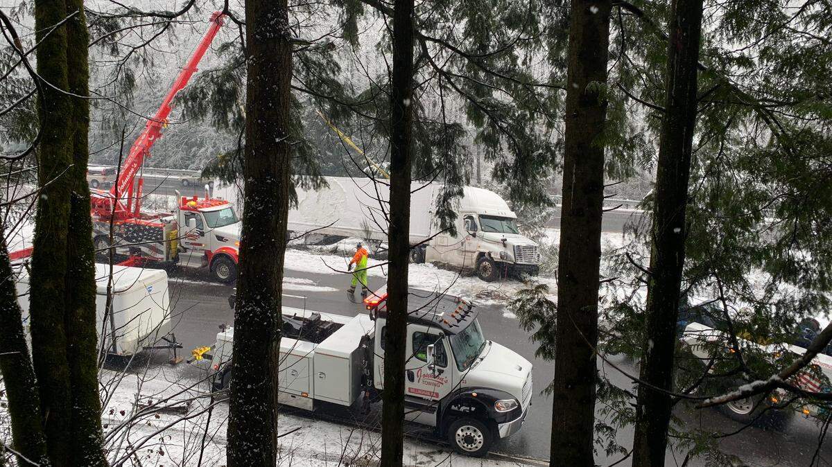 A crane helps right a semi that overturned on southbound Interstate 5 near the North Lake Samish exit early Friday south of Bellingham.