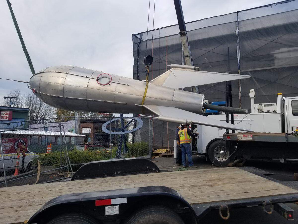 The rocket sculpture in the lot next to the former Rocket Donuts is removed at the end of October in downtown Bellingham. Owner Mike Hammes, who is retrofitting the Holly Street building next door, was unable to save the Lanny Little mural on the exterior wall, but the rocket sculpture is being refurbished and will return this winter.