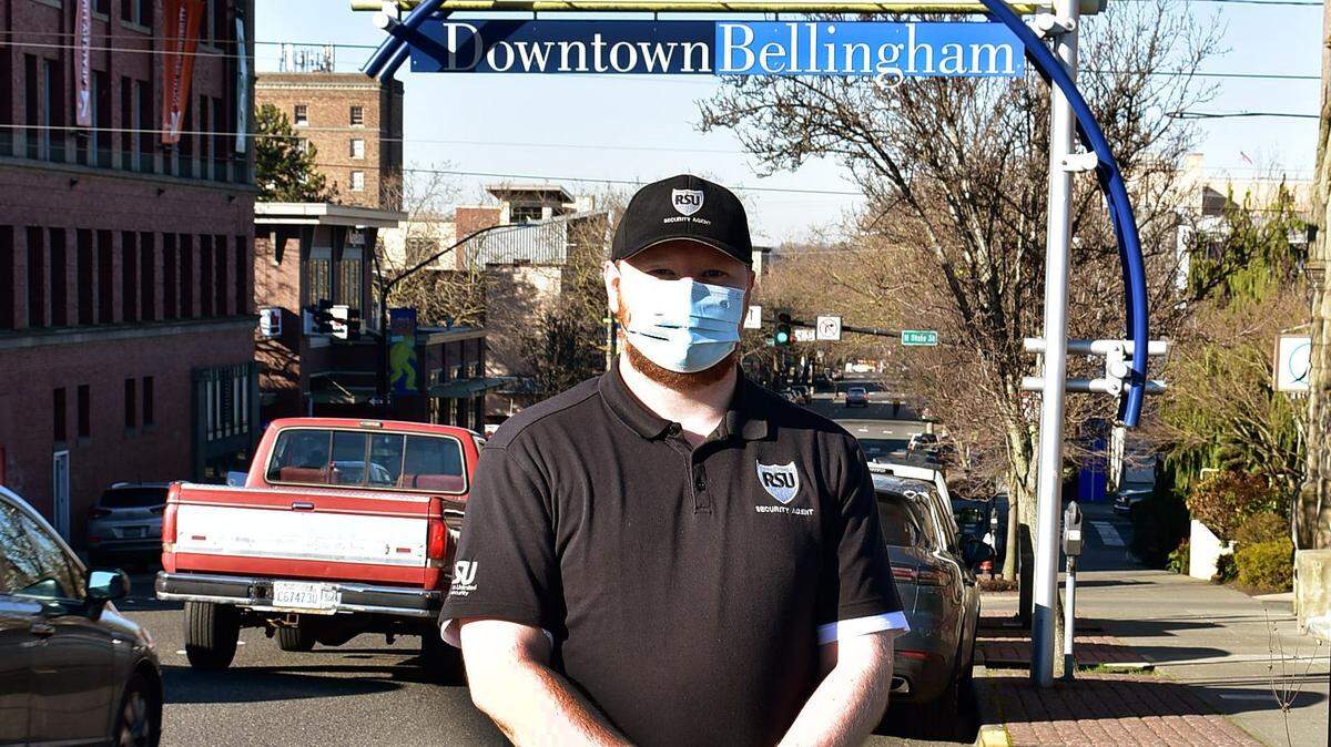 An employee of Risk Solutions Unlimited is shown near Holly and State streets in downtown Bellingham in an undated photo from the city. City officials hope unarmed patrols will provide a deterrence to crime, help people in need connect to social services and provide outreach to business owners and downtown visitors.