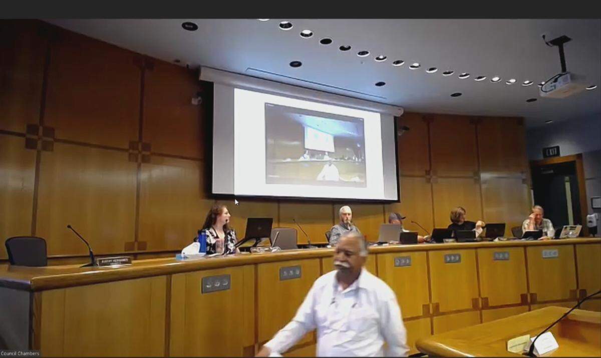 In this screengrab from the video recording of a July 11, 2023, meeting of the Whatcom County Council, County Executive Satpal Sidhu walks toward the lectern to address the council at the Whatcom County Courthouse in Bellingham, Wash.