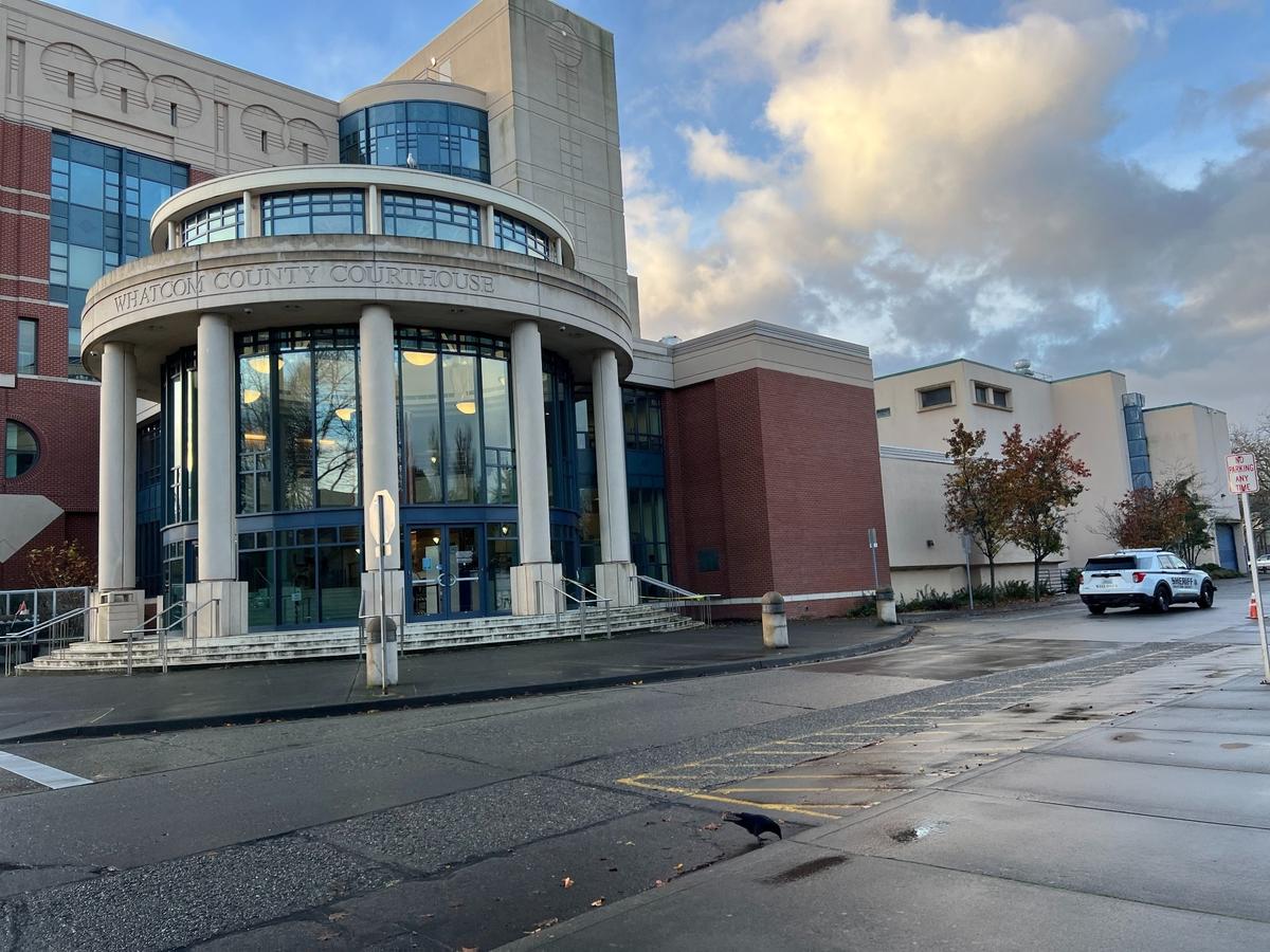 A Whatcom County Sheriff’s patrol car cruises part the County Courthouse on Nov. 18. A burglar smashed the front door and broke open an ATM inside.