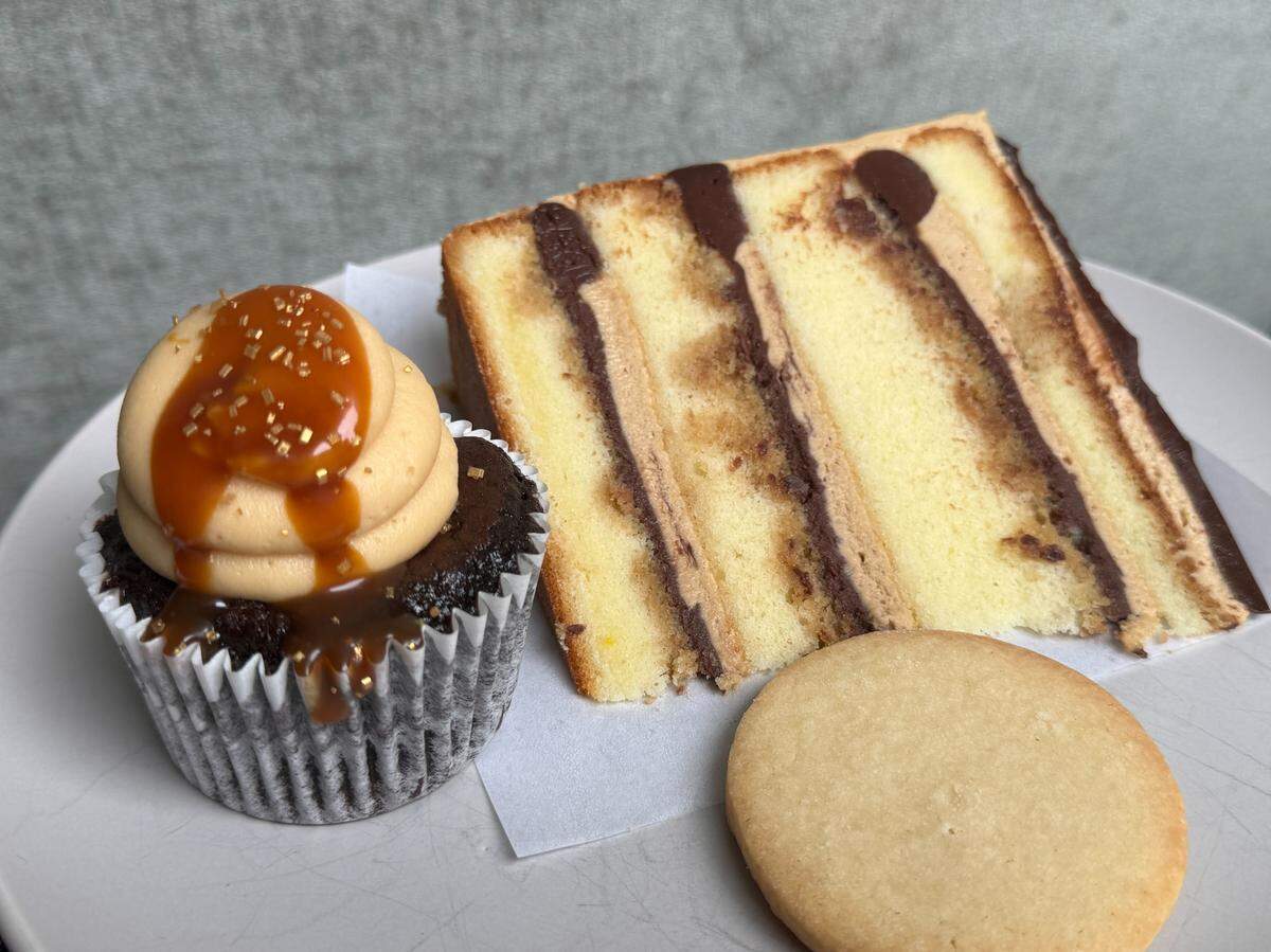A slice of tirimisu cake, a chocolate salted caramel cupcake and almond shortbread cookie from Pure Bliss Desserts.