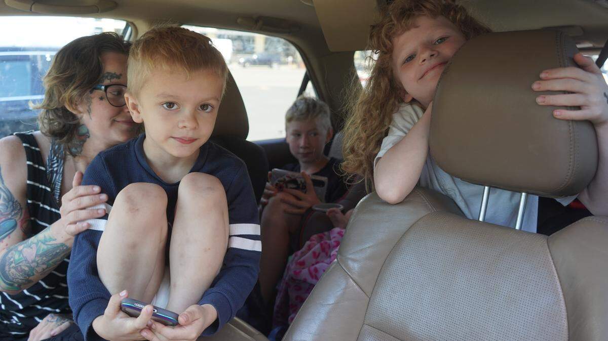 Cassandra and her six children sit in their vehicle on July 27, 2023, in a parking lot in downtown Bellingham, Wash.