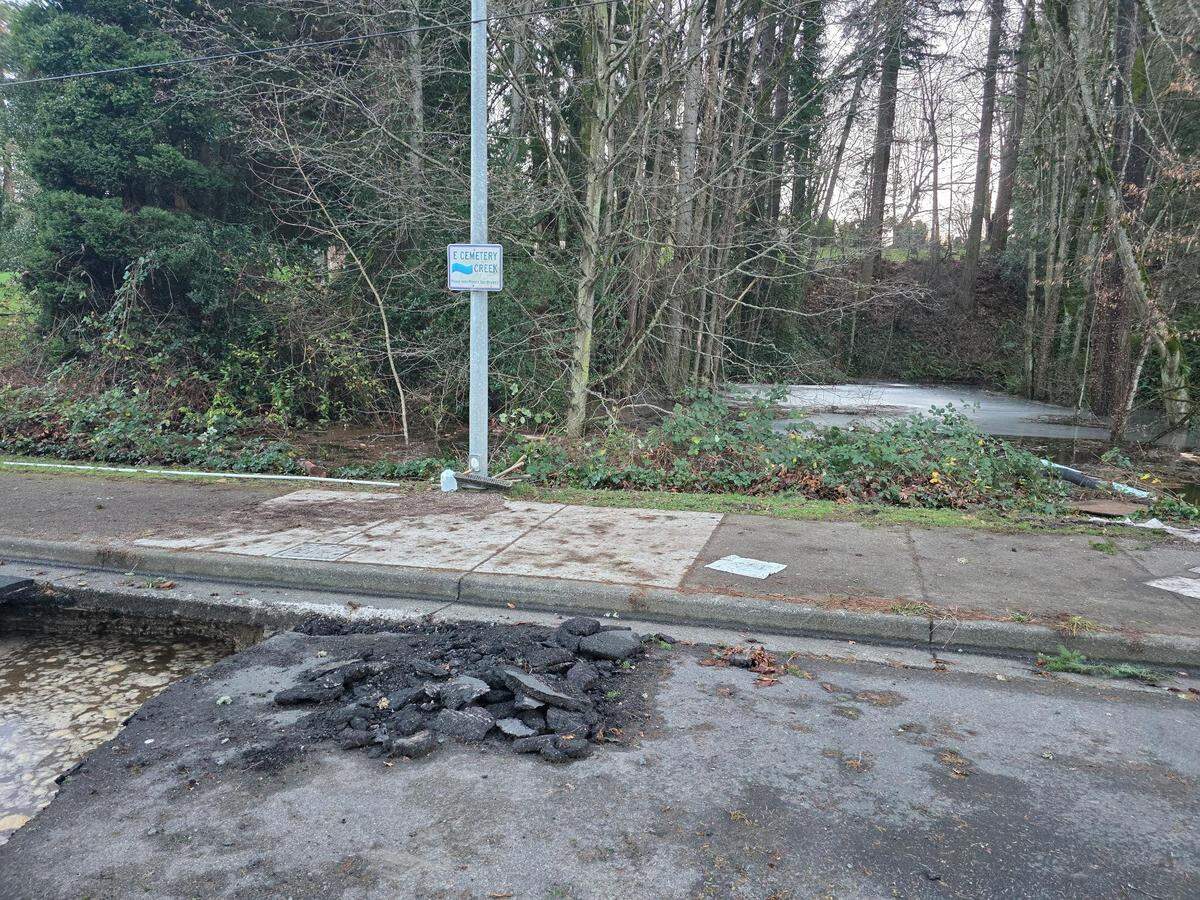 A section of Woburn Street between Lakeway Drive and Fraser Street was damaged by water overflowing from Cemetery Creek, the city of Bellingham said in a Dec. 17, 2025, post on Facebook. A series of storms from a pair of atmospheric rivers drenched Western Washington in mid-December.