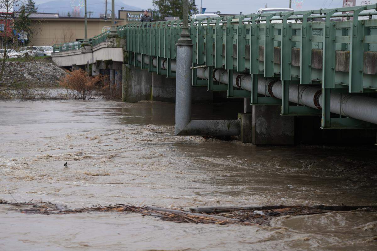 The Nooksack River flows under the Main Street Bridge on December 10, 2025, through Ferndale, Wash., as the city issued a voluntary evacuation order amid rising waters and flooding.