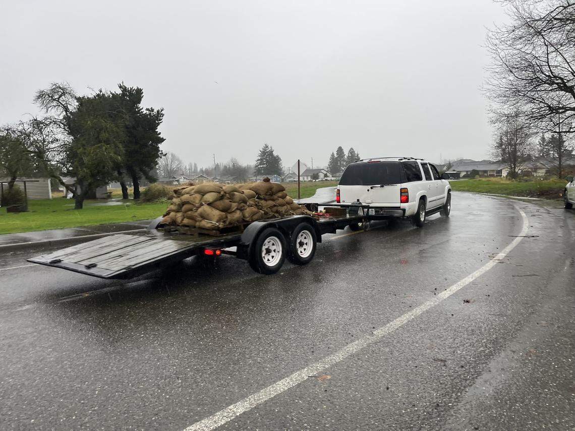 A vehicle hauls a trailer full of sandbags in Sumas as residents prepared for possible flooding Dec. 10, 2025.