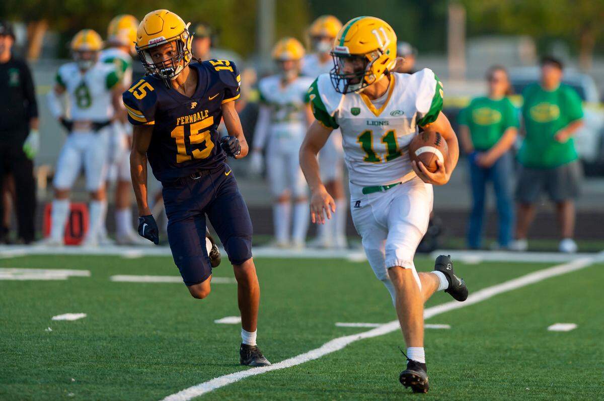 Lynden kicker Troy Petz (11) runs for a touchdown after he faked a punt Friday evening Sept. 2, at Blaine High School. His touchdown and resulting extra point gave Lynden its first score as it went on to defeat Ferndale 24 to 7 in the season opener.
