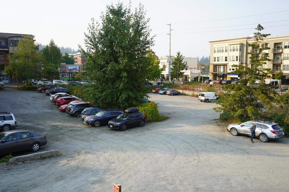Cars park Thursday, Oct. 6, on the site of a proposed mixed-use housing development in Fairhaven.