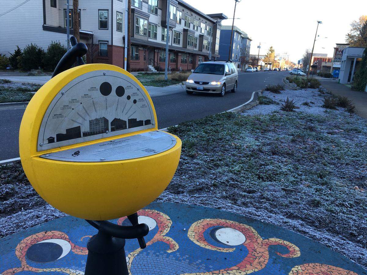 A model of the sun contains information describing the “Solar System” project as a scavenger hunt for nine planets, including the dwarf planet Pluto, near the roundabout connect State, Forest, Boulevard and Wharf streets.