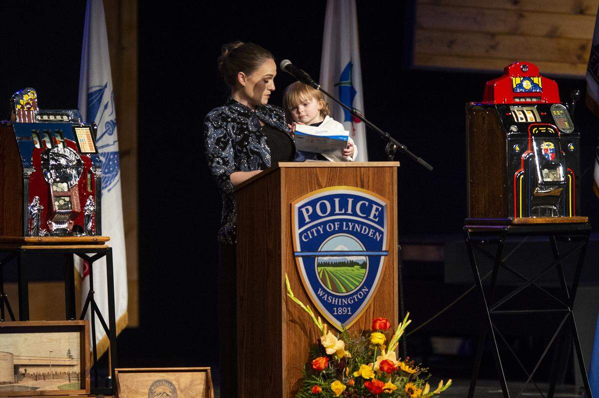 Lindsay Knapp Lyles, Lynden interim Police Chief Michael Knapp’s daughter, looks to her 2-year-old daughter while speaking at her father’s memorial service at Christ the King Community Church in Bellingham Wednesday.