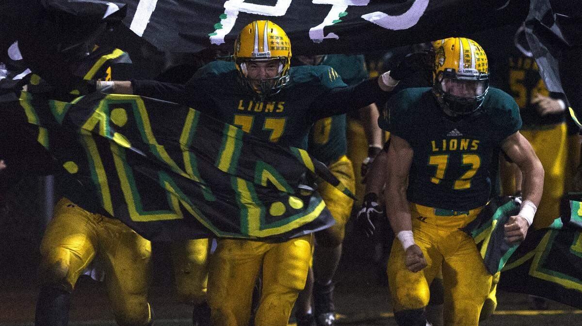 Lynden football players take the field in 2014. The 2018 Whatcom County football season kicks off with seven games on Friday night.