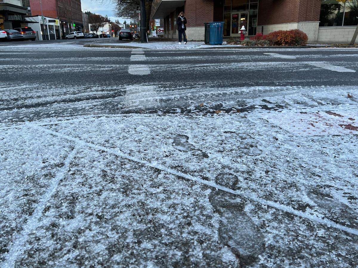 An overnight sprinkling of graupel — a kind of soft hail — coats streets and sidewalks Monday, Nov. 28, in parts of Bellingham and lowland Whatcom County, including the intersection of State and Holly streets downtown.