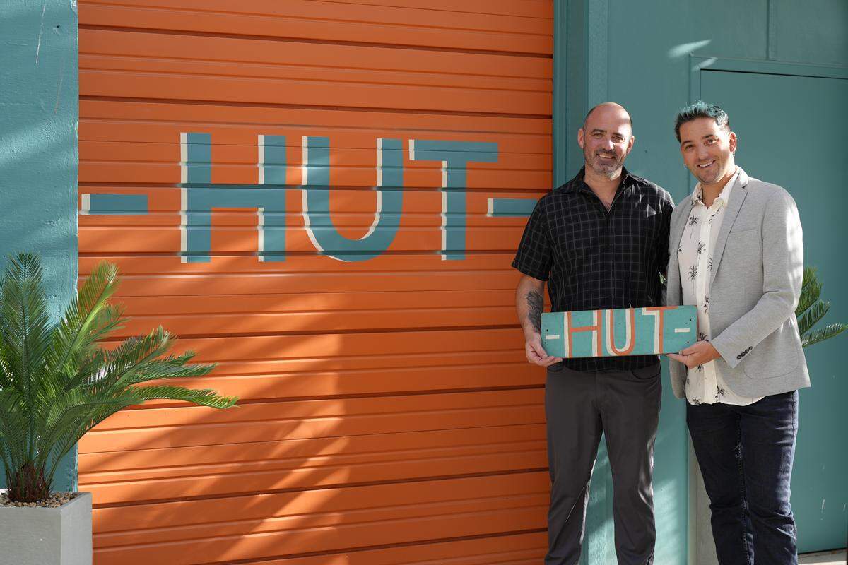 Rumors Cabaret owners Rian Greer (left) and Andrew Keith stand outside their newest venture, HUT, on Oct. 2, 2025, in Bellingham, Wash. HUT is a nightclub for people ages 18 to 24 and a rentable venue in the space underneath Rumors.