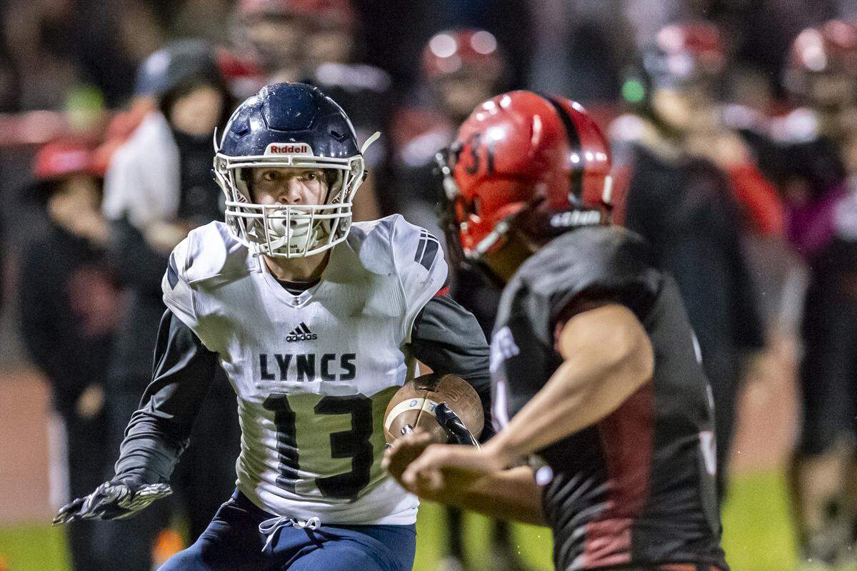 Lynden Christian wide receiver Jackson Corkill tries to avoid Mount Baker defensive lineman Jason Lee Oct. 18. Six years after he caught the eye of Lynden Christian football coach Dan Kaemingk during a game of catch, Corkill has become a threat for the Lyncs, who face Deer Park in the Class 1A state semifinals.