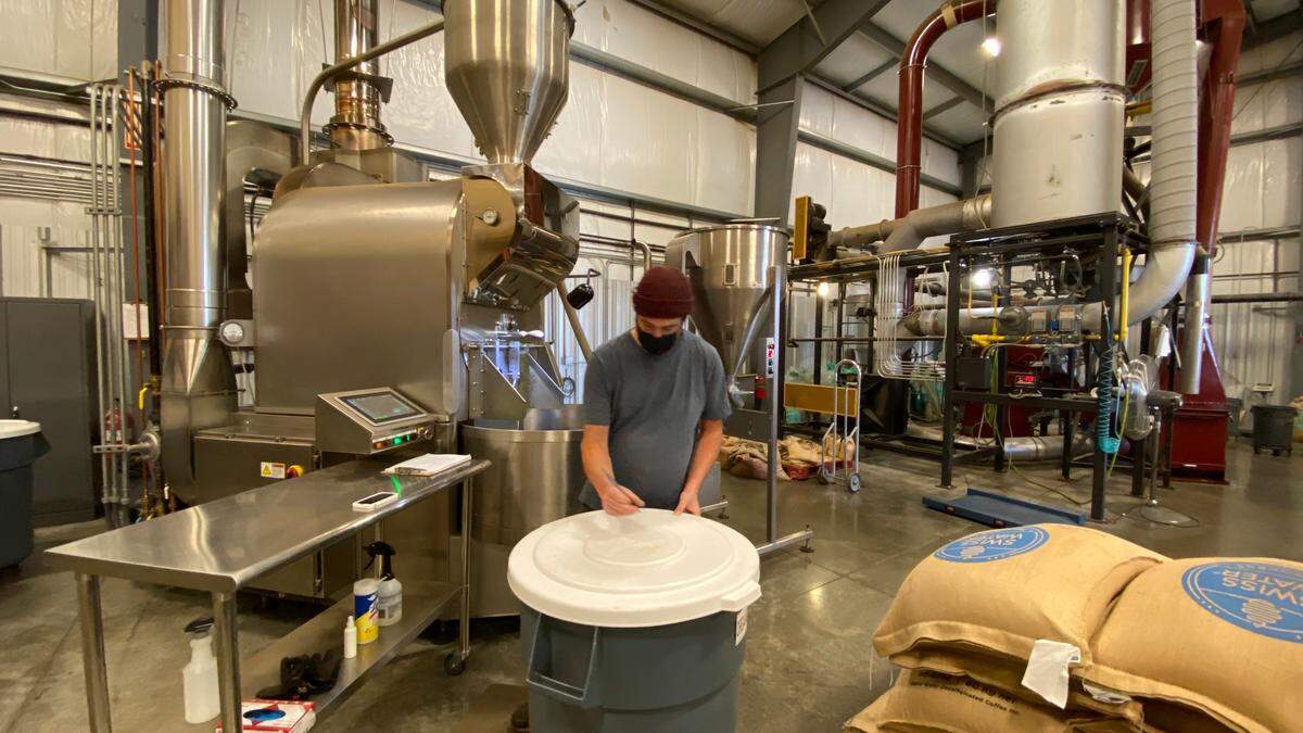 A roaster for Tony’s Coffee labels a batch of beans on Thursday, Oct. 29, at their production facility in Bellingham.