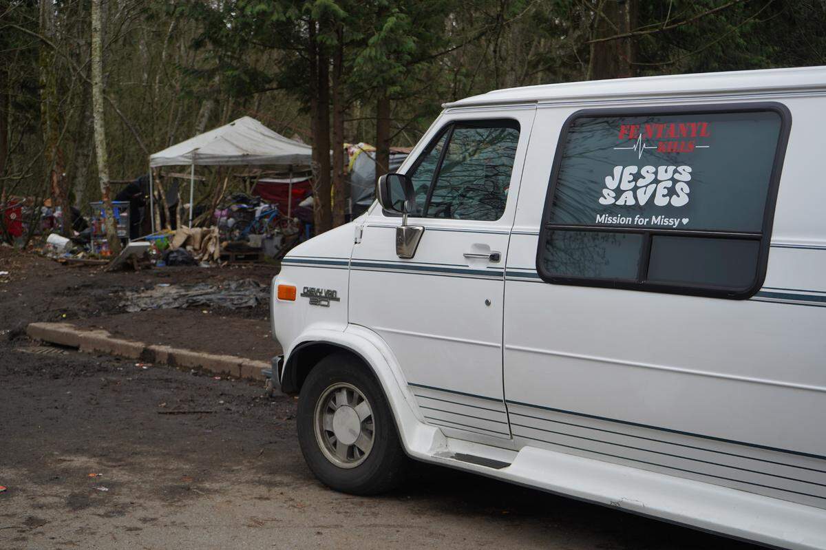 Hanah Warthan’s van is parked outside of the encampment behind Walmart on Dec. 29, 2023, in Bellingham, Wash. A decal on the van reads ‘Fentanyl kills, Jesus saves,’ the motto for Warthan’s organization, Mission for Missy. The group’s mission is to help spread awareness about the dangers of fentanyl and support people experiencing homelessness.