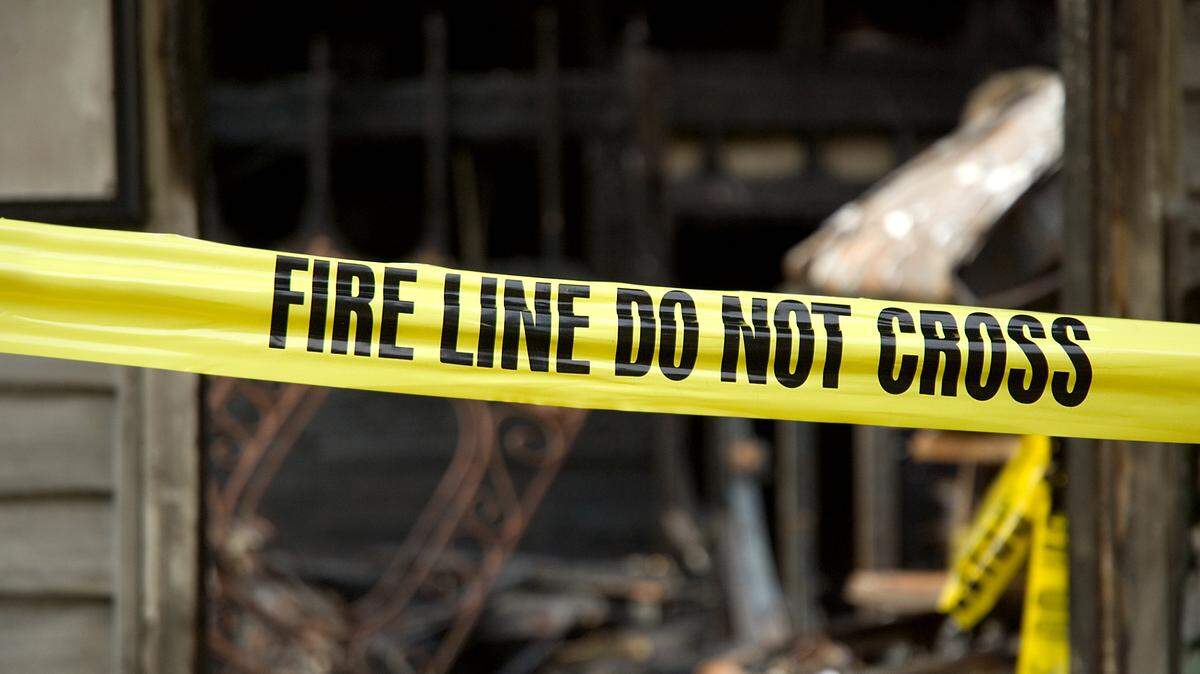 Fire line in front of a destroyed home.