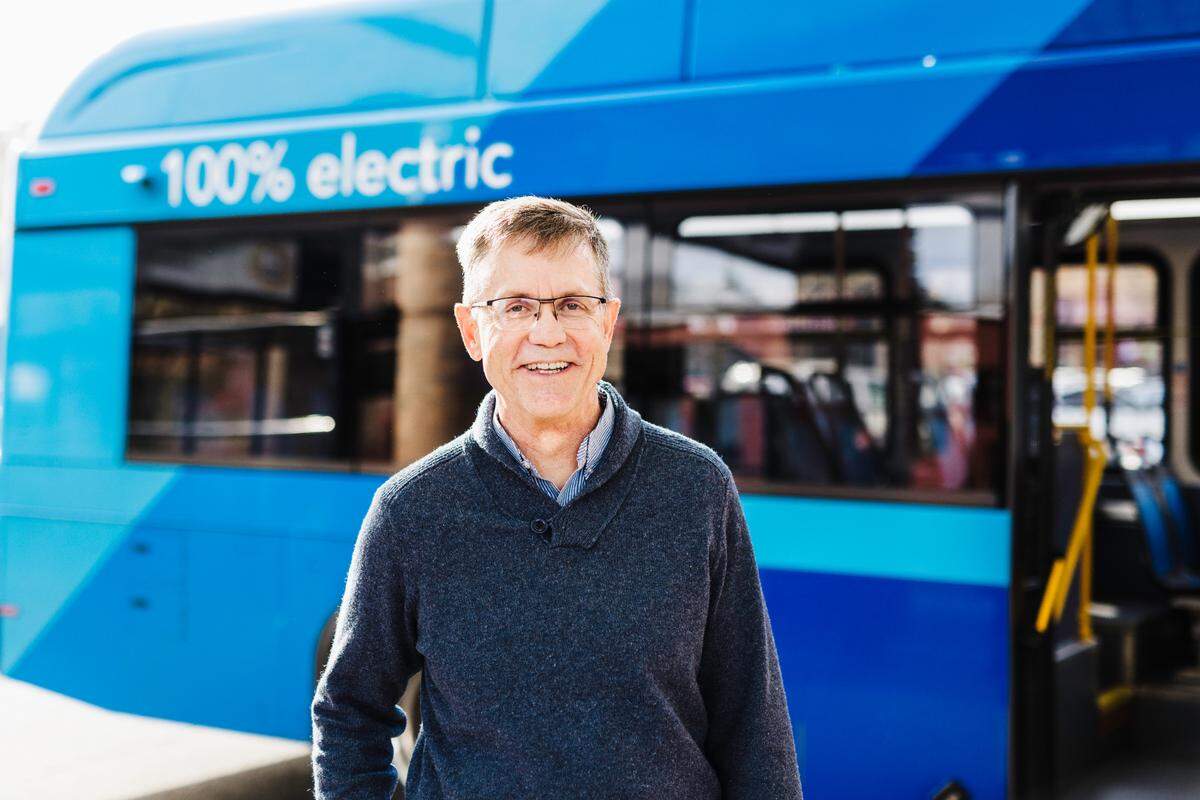 Les Reardanz, General Manager at Whatcom Transit Authority and former Navy Reservist, stands in front of a WTA electric bus in an undated file photo in Bellingham, Wash.