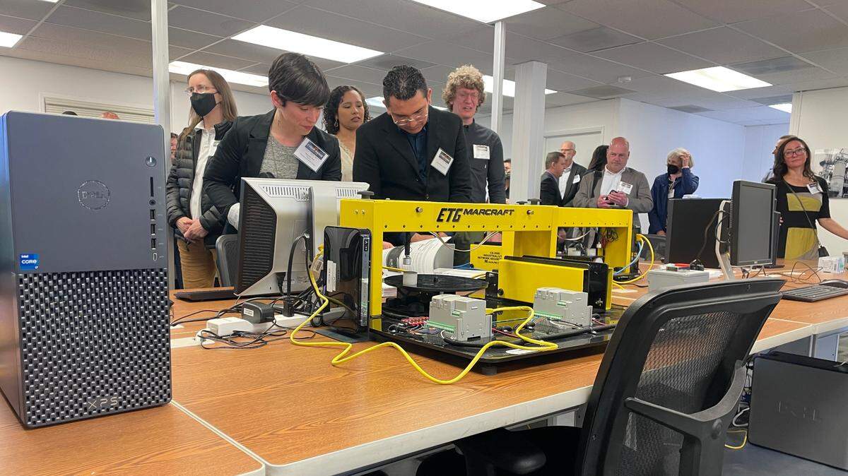 Visitors check out Whatcom Community College’s new Industrial Control Systems Cyber Range Wednesday, May 18, on Anvil Corp.’s campus near the Bellingham International Airport. The center focuses on training against cybersecurity attacks.