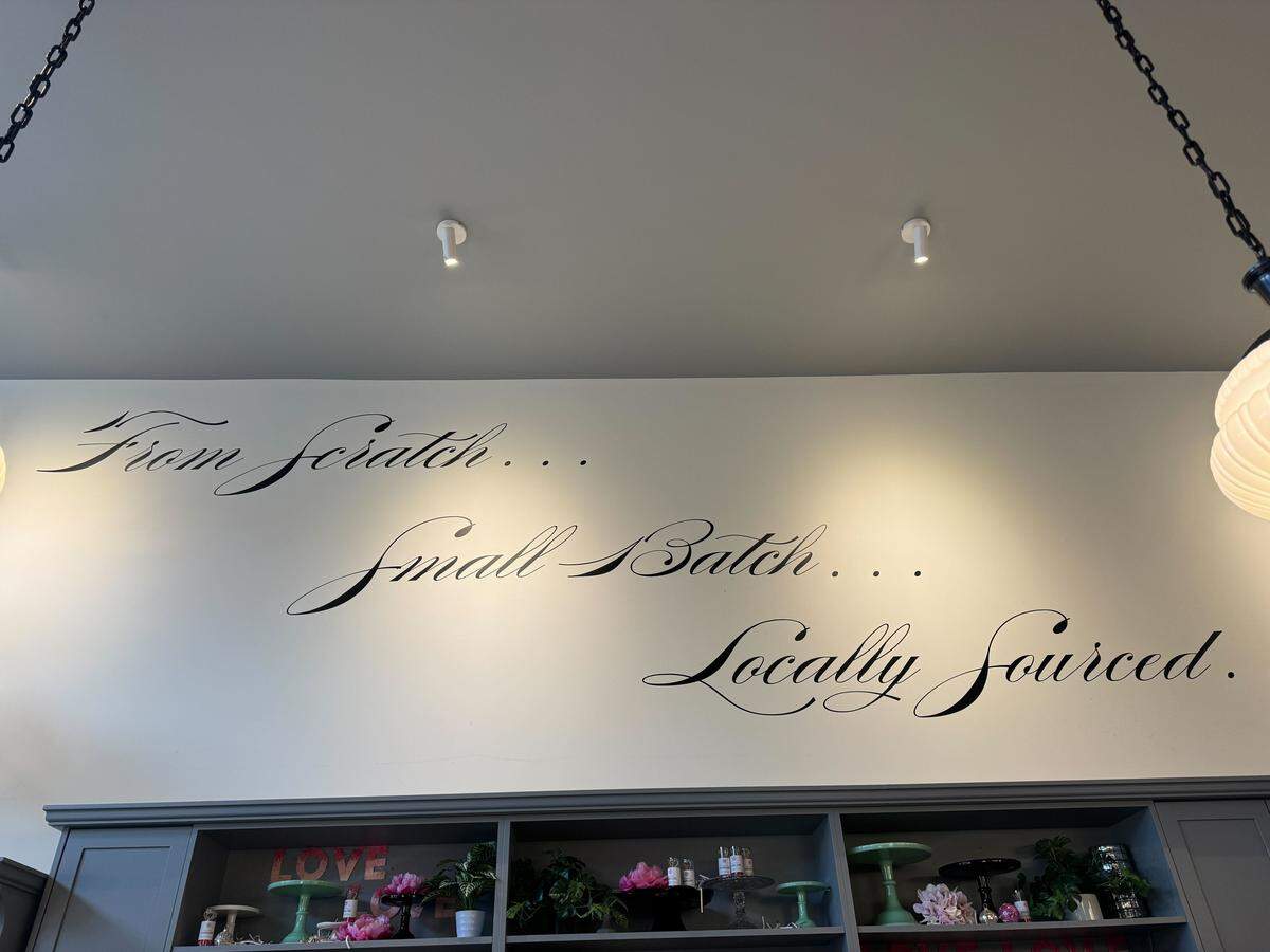 Wall art that reads “From Scratch ... Small Batch ... Locally Sources ...” at Pure Bliss Desserts.