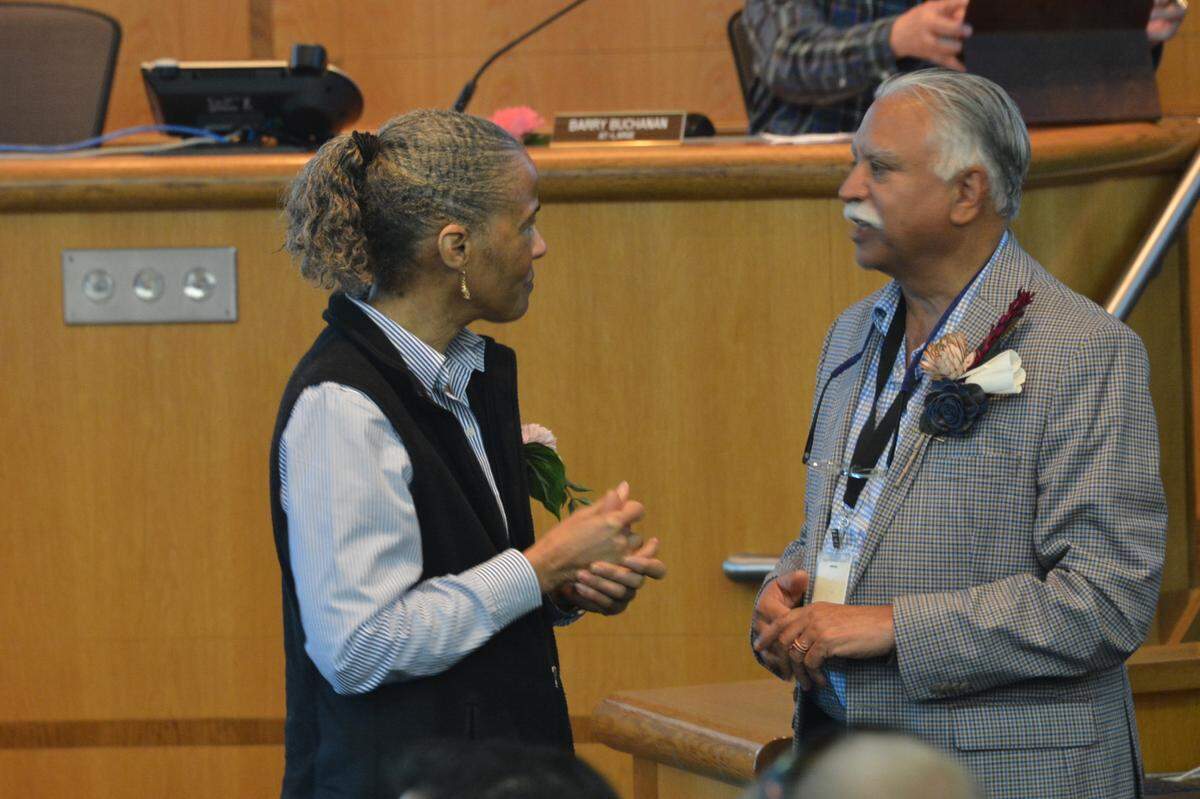 Whatcom County Executive Satpal Sidhu, right, chats with a member of the audience before the County Council meeting Tuesday, Oct. 11, where the formation of a Racial Equity Commission was approved.