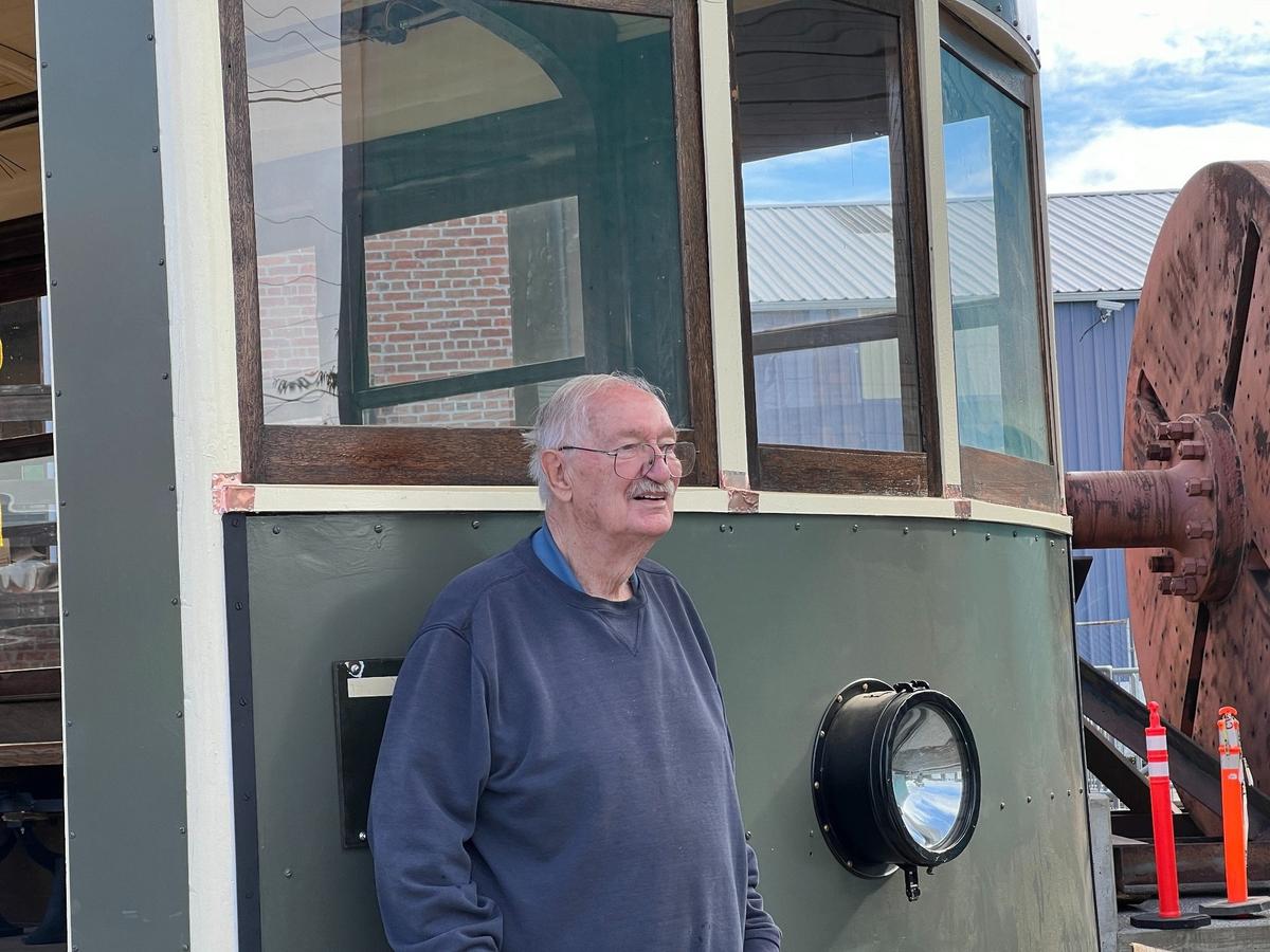 Tom Mendenhall of the Arlington company Historic Railway Restoration stands in front of a restored 1924 streetcar at the corner of West Holly and E streets in the Old Town district of Bellingham on Wednesday. The Birney Safety Car was part of a line that ran through several sections of town.