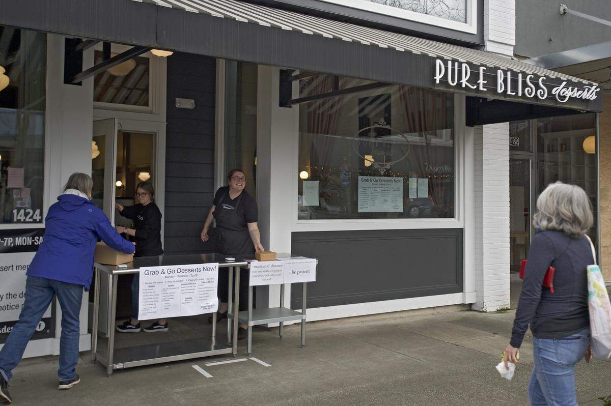Pure Bliss Dessert employees deliver treats to customers on Thursday, April 23, in Bellingham. The business is using the federal payroll protection program to continue to pay its employees during closures related to the coronavirus pandemic.